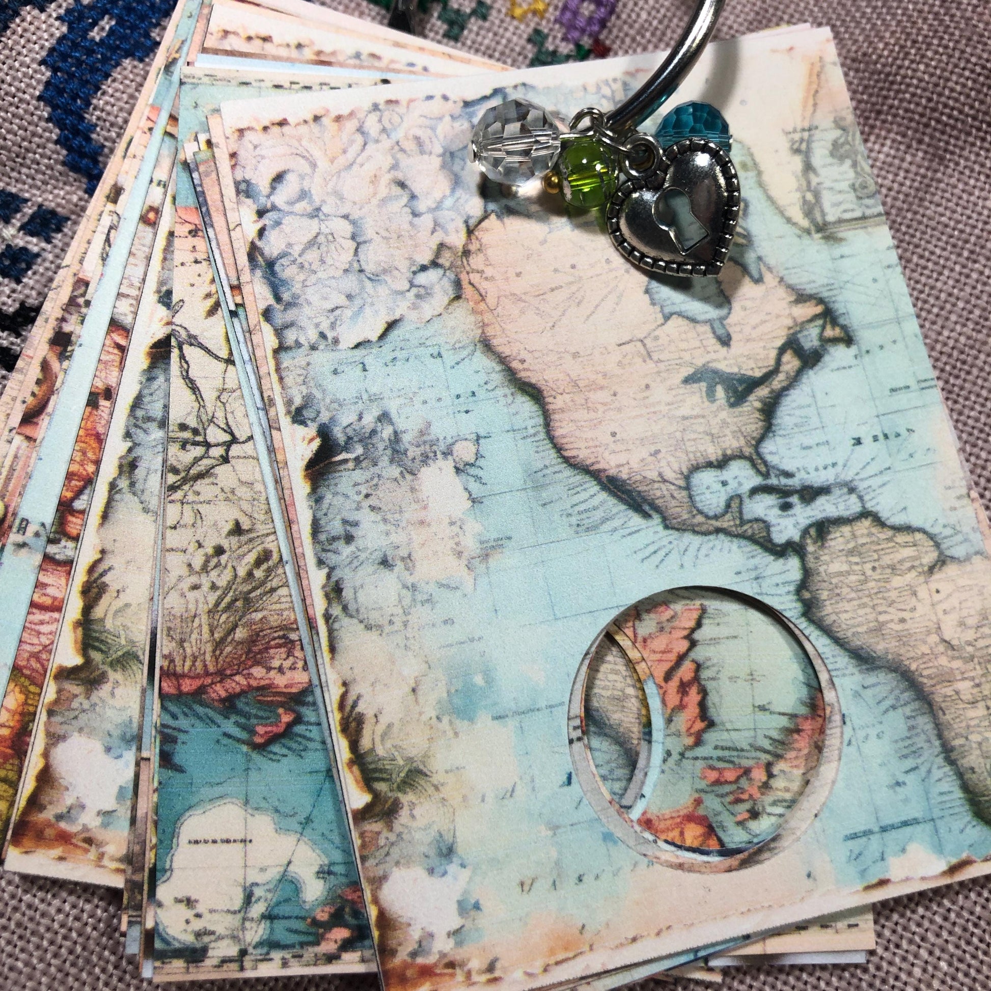 World map themed floss drops for cross stitch thread organisation.