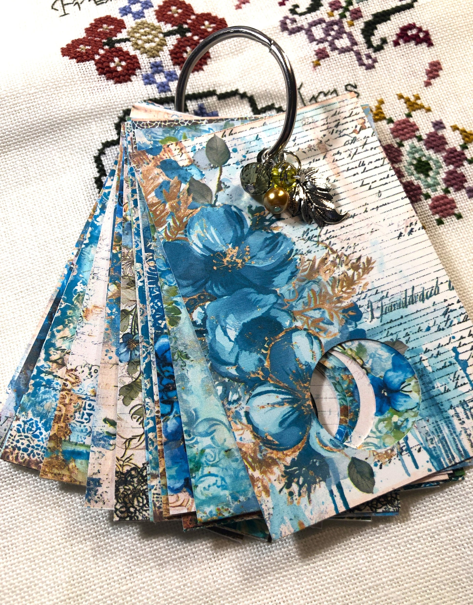 Aqua floral themed floss drops for cross stitch thread organisation.