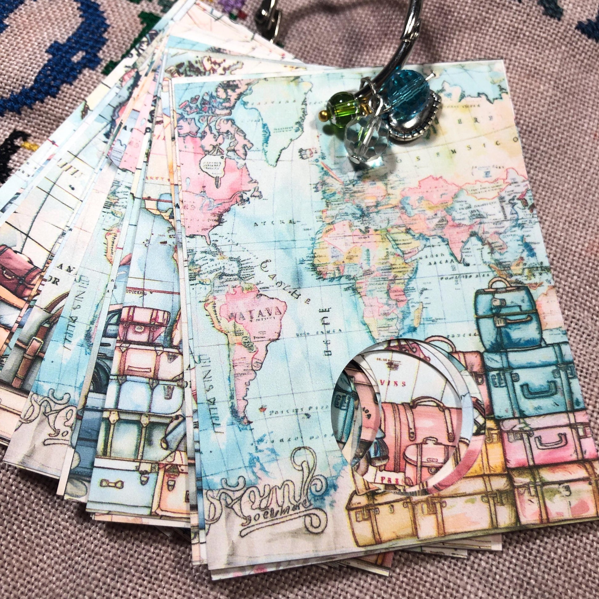 World map themed floss drops for cross stitch thread organisation.