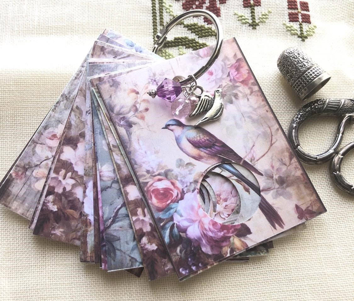 Floral birds floss drops for cross stitch thread organisation.