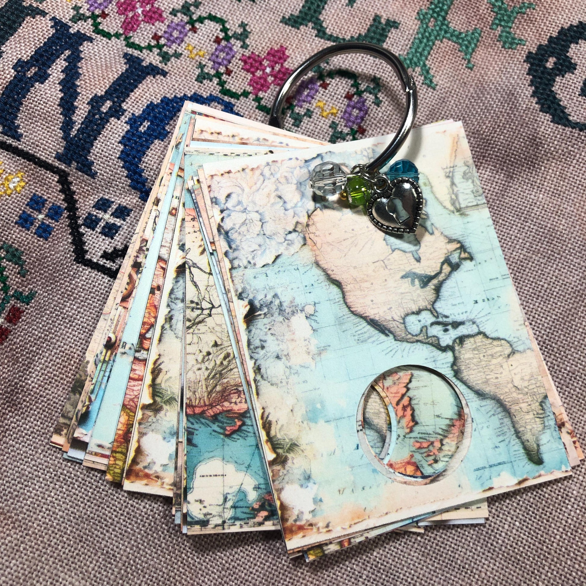 World map themed floss drops for cross stitch thread organisation.