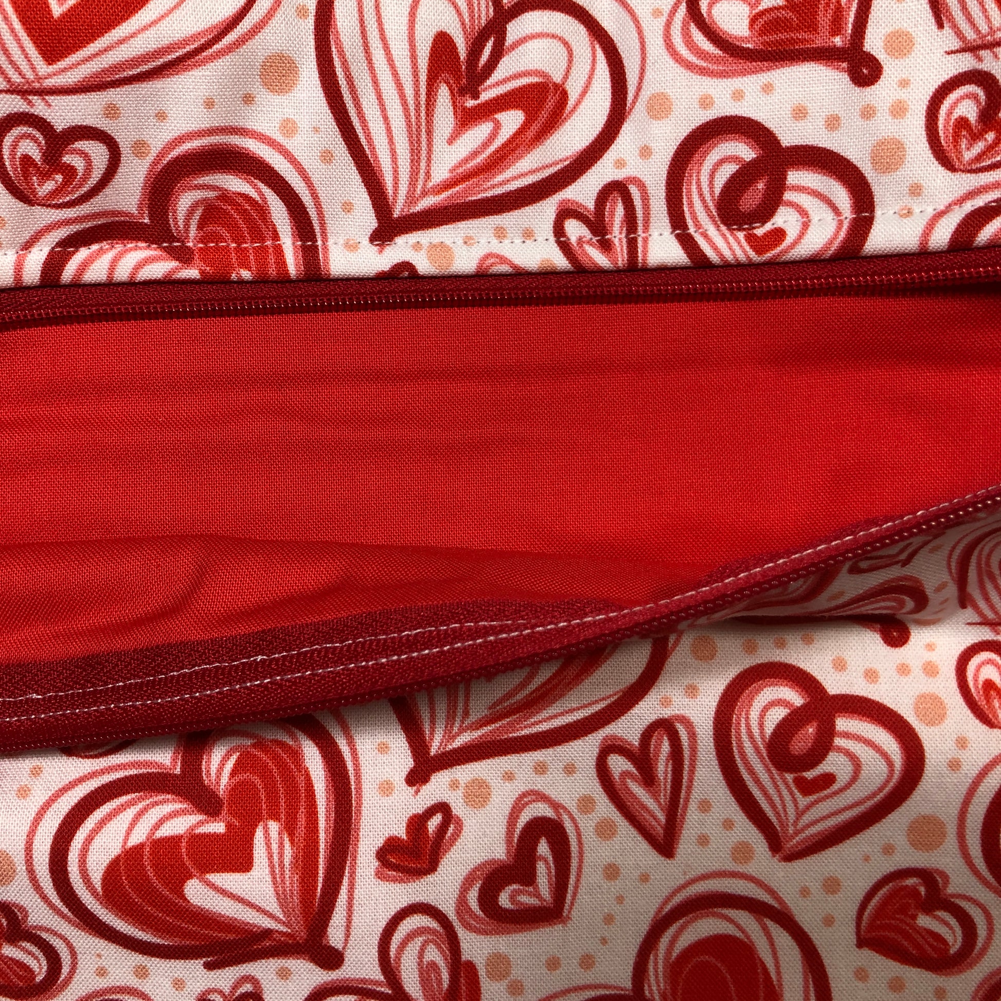 Red heart patterned project bag for cross stitch.