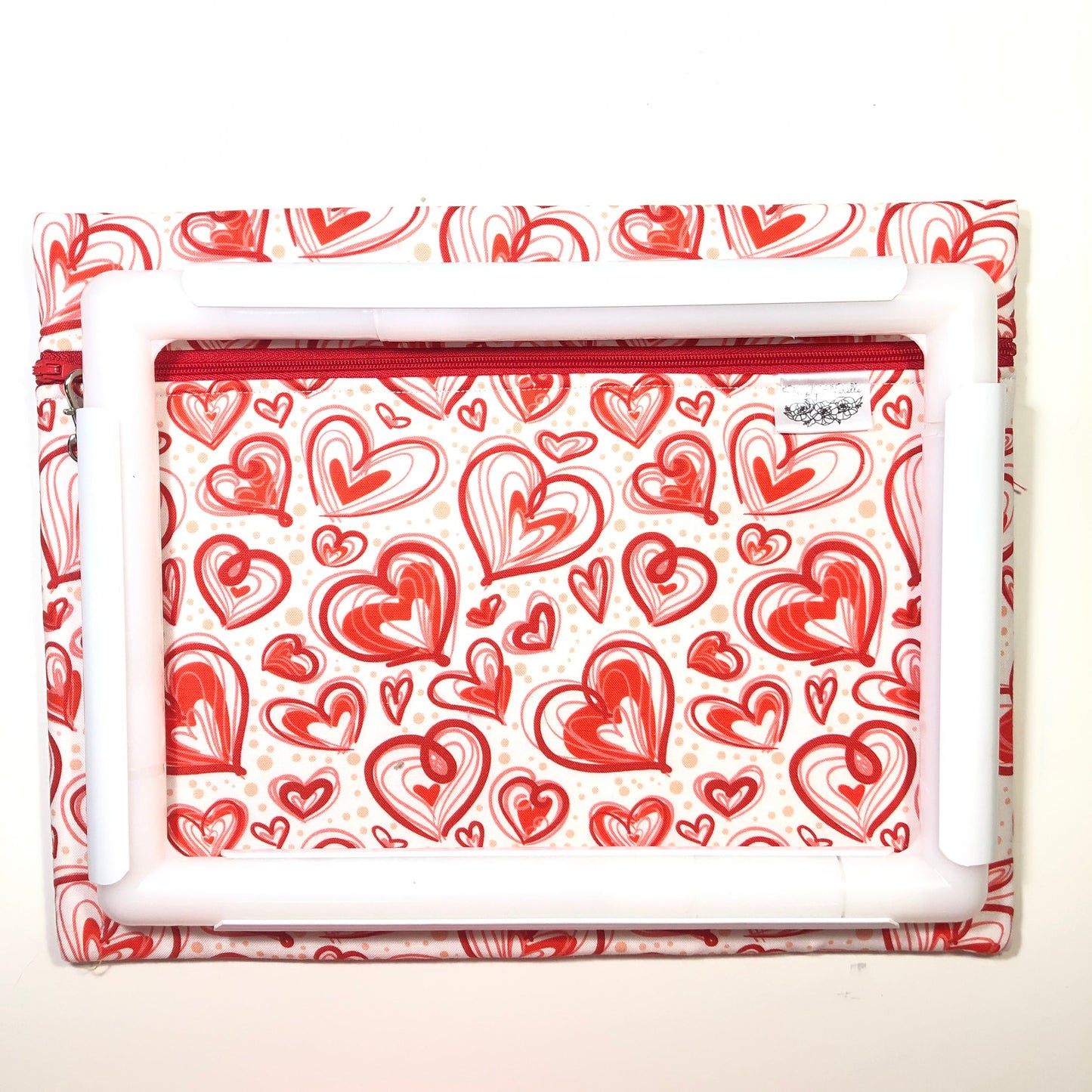 Red heart patterned project bag for cross stitch.