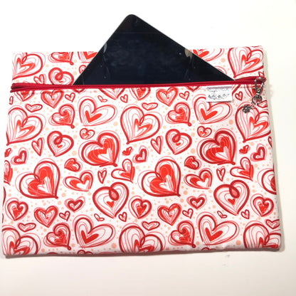 Red heart patterned zippered pouch for tablet storage.